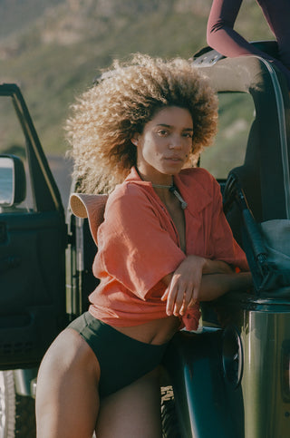 Model wearing Clifton bikini bottom in Forest green.